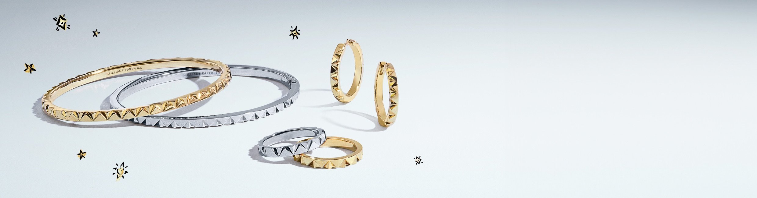 Model wearing an assortment of yellow gold and white gold jewelry from the Sol Collection.